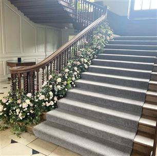 Chicheley Hall, Buckinghamshire Wedding venue has a super grand staircase entrance that can be decorated with lush floral garlands down the stairs or flower meadows