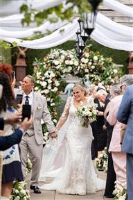 Same sex wedding couple walking down the aisle after the ceremony has finished