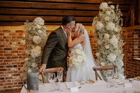 The barn at Redcoats sweetheart table set up with floral pillars
