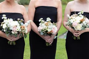 Blush coloured wedding bouquets held by bridesmaids